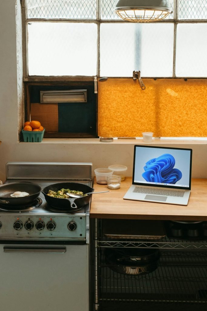 a-laptop-computer-sitting-on-top-of-a-stove-top-oven-dnvmy2qdmy4